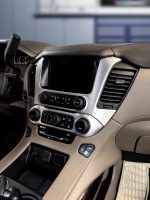 Interior view of a car dashboard featuring control buttons and a display screen.