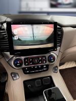 Interior view of a car dashboard featuring a touchscreen display and control buttons.