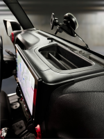Close-up view of a car dashboard featuring a navigation screen and a phone mount.