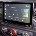 Sony car infotainment system showing music playback interface with album art and controls.