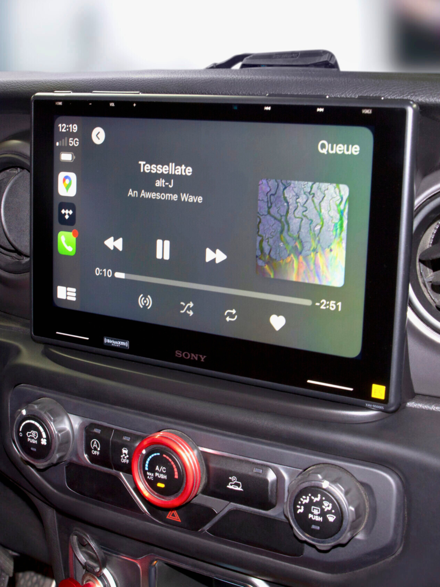 Sony Car Infotainment System Display Sony car infotainment system showing music playback interface with album art and controls.