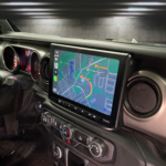 Car dashboard featuring a modern navigation system with a detailed map display and control buttons for audio and climate settings.