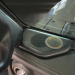 Tweeter pod installed in a Jeep JL JT vehicle, featuring a black mesh design and a circular speaker element.