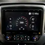 Sony XAV9500ES 10.1-inch touchscreen display with analog gauges, time readout, and “SONY” branding on a black dash panel
