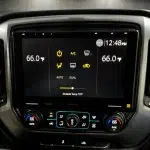 Black Sony 10.1" touchscreen shows 12:48 PM and 66.0°F dual climate icons, matching the look for Chevrolet Silverado and GMC Sierra.