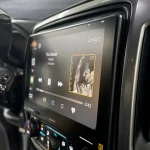 10.1-inch touchscreen display showing media playback on a Sony XAV-9500ES receiver in a black dash setup