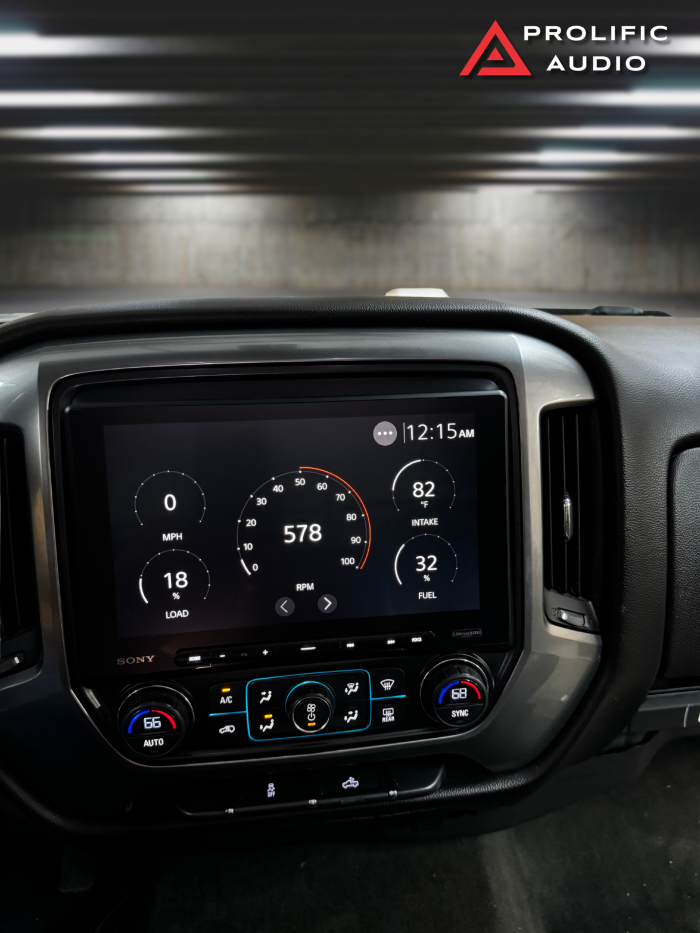 Sony XAV-AX8500 showing RPM, load, intake temperature, and fuel level on the display in a 2014-2019 Chevrolet Silverado or GMC Sierra.