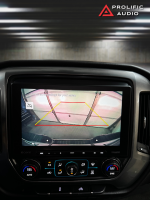 Rearview camera image displayed on the Sony XAV-AX8500 multimedia receiver installed in a 2014-2019 Chevrolet Silverado or GMC Sierra, showing parking guidelines and enhanced visibility.