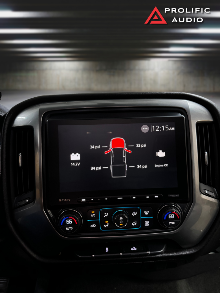 Sony XAV-AX8500 display showing tire pressure readings, battery voltage, and engine status for a 2014-2019 Chevrolet Silverado or GMC Sierra.