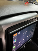 Close-up view of the Sony XAV-AX8500 installed in a 2014-2019 Chevrolet Silverado or GMC Sierra, displaying the CarPlay interface with "Too Sweet" by Hozier playing.