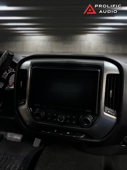 A powered-off Sony XAV-AX8500 multimedia receiver installed in the dashboard of a 2014-2019 Chevrolet Silverado or GMC Sierra.