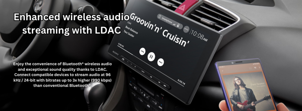 Interior of a car with a Sony XAV-AX8500 radio displayed on the dashboard, showing the song 'Groovin' n' Cruisin' by Beat Balance. The screen highlights 'Enhanced wireless audio streaming with LDAC,' allowing Bluetooth audio streaming with high bitrate. A person holds a smartphone with album art for the song 'Two Seater,' showing compatibility with the radio.