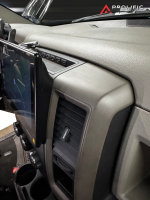 Interior view of a Dodge vehicle dashboard with a mounted tablet holder and air vent.