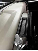Close-up view of a Dodge vehicle's dashboard with a speaker and control panel.