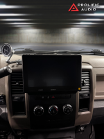 Car interior featuring a Sony display screen mounted on the dashboard with control knobs and a gauge.