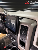 Car interior featuring a touchscreen display with music playback interface and dashboard controls.