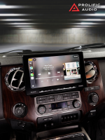 Sony car stereo system displaying music playback interface in a vehicle interior.