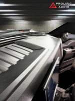 Close-up view of a vehicle dashboard with a touchscreen display and textured surface.