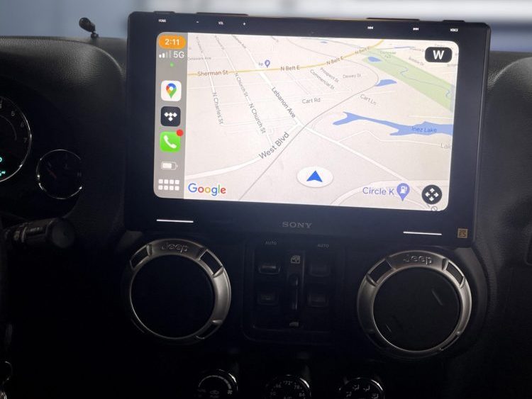 Sony car stereo display showing a navigation map with various icons and a Google logo.